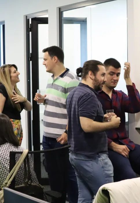Colleagues talking over coffee in the office
