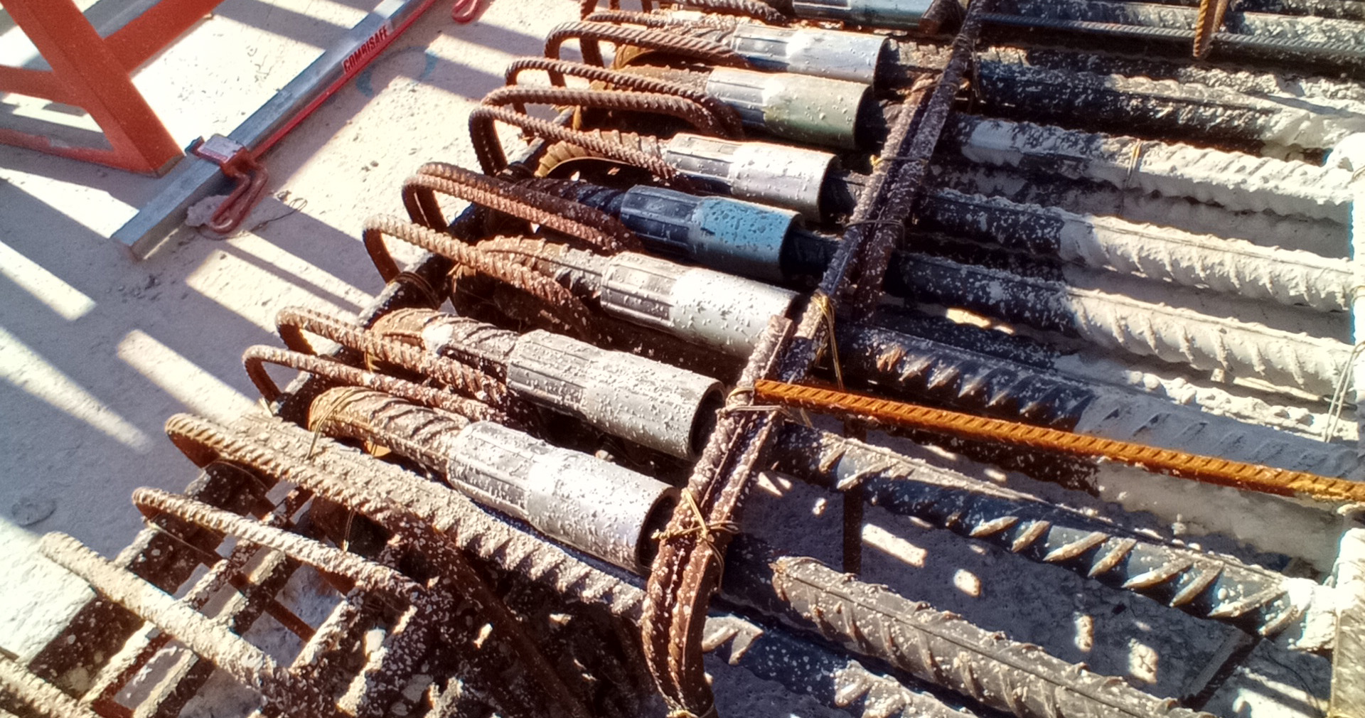 Reinforcing bar couplers installed on site, connecting rebars during concrete construction